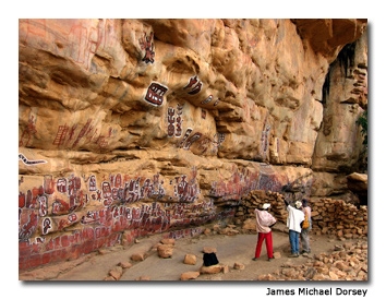 A nearby cave used for rituals is hand-painted with thousands of red, white and black images representing all the families of the area.